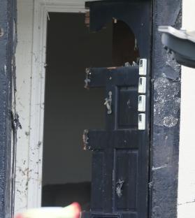 Damaged door after counter-terrorism raid.