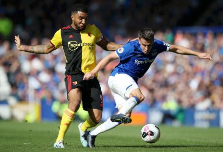 Photo of Troy Deeney and Seamus Coleman vying for the ball during a soccer match.