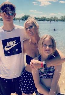 Woman and two children at a lake.