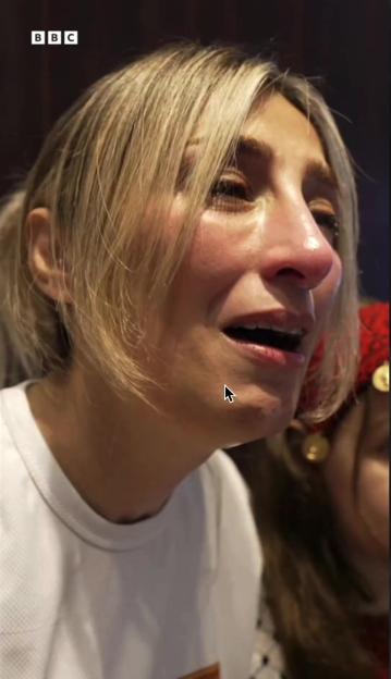Aida Abu Rob crying with the BBC logo visible in the top left corner.