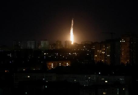 Drone explosion over a city at night.
