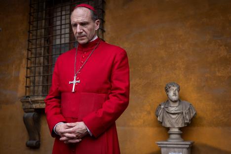 Ralph Fiennes in a red cardinal's robe.