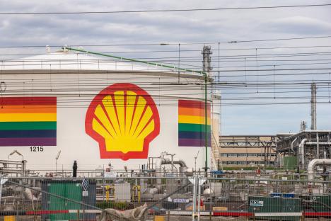 Shell logo and rainbow on an oil storage silo at a refinery.