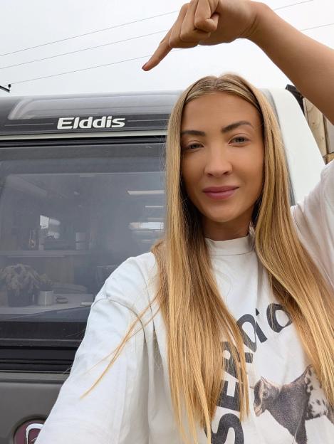 Woman pointing at Elddis caravan.
