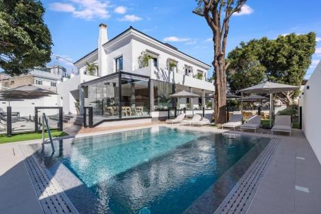 Hotel with pool and outdoor seating area.