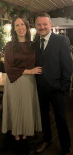 A woman and man posing for a photo.