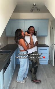 Couple embracing in a kitchen.