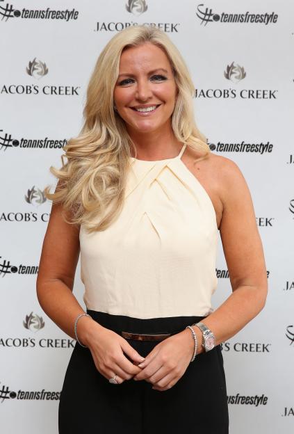 Michelle Mone posing in front of a white background with "Jacob's Creek" and "#tennisfreestyle" logos.