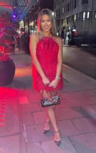 Woman in red feathered dress and black heels.