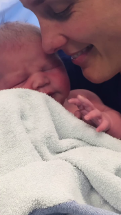 A mother cradling her newborn baby.
