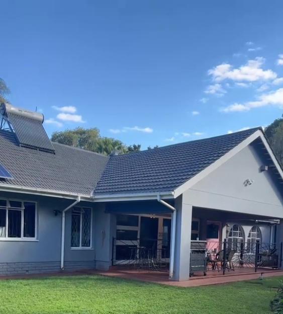 House with a patio and lawn.