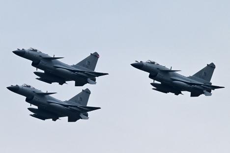 Three Pakistan Air Force J-10C fighter jets in flight.