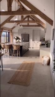 Modern kitchen with exposed wooden beams and a large island.