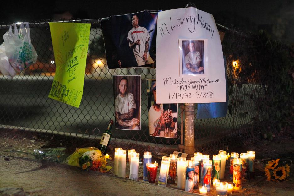 Makeshift memorial to Mac Miller with candles and photos.