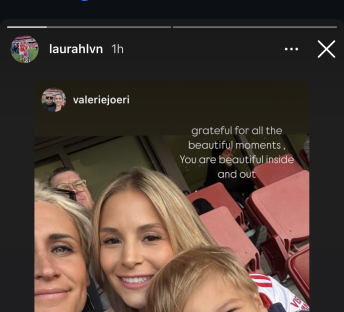 Selfie of two women and a child in a stadium.