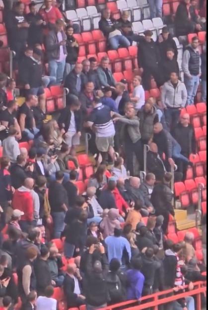 Fight breaking out in stadium seating.
