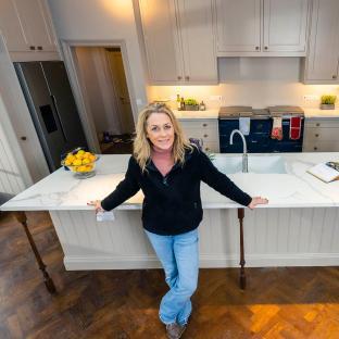 Sarah Beeny standing in her new kitchen.
