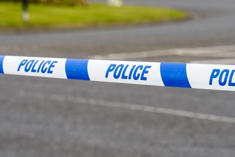 Police tape cordoning off a crime scene.
