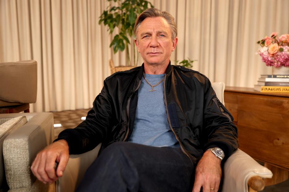 Daniel Craig sitting in a chair.