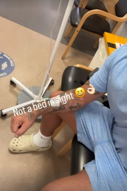 Man in a waiting room receiving an IV drip.