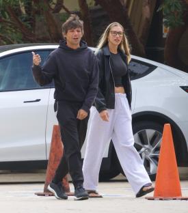 Louis Tomlinson and Zara McDermott walking hand-in-hand.
