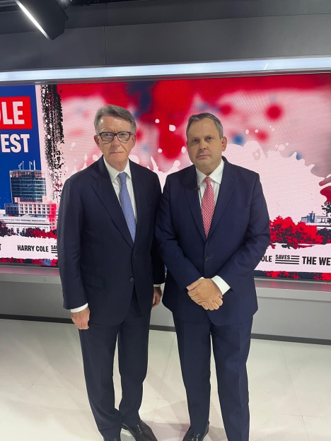 Two men in suits standing together.