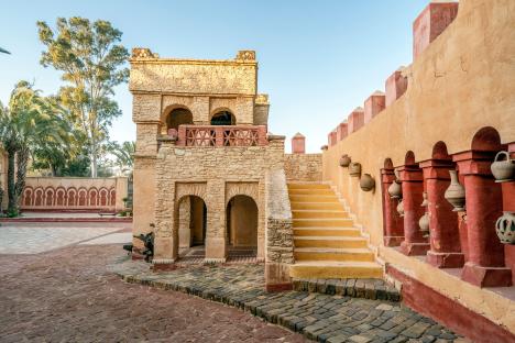 Stone building with arched doorways and a staircase in Agadir, Morocco.