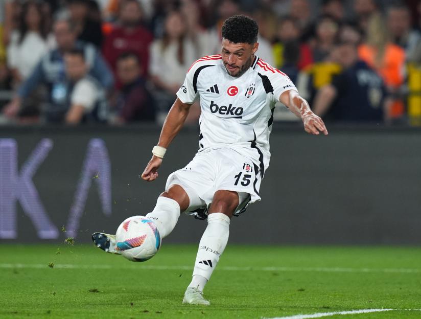 Alex Oxlade of Besiktas kicking a soccer ball.