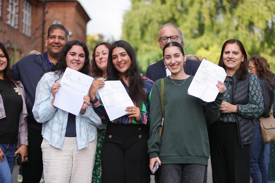a group of people holding up papers that say ' a ' on them