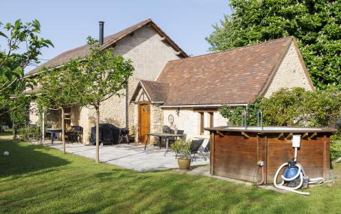 Stone house with brown tile roof.