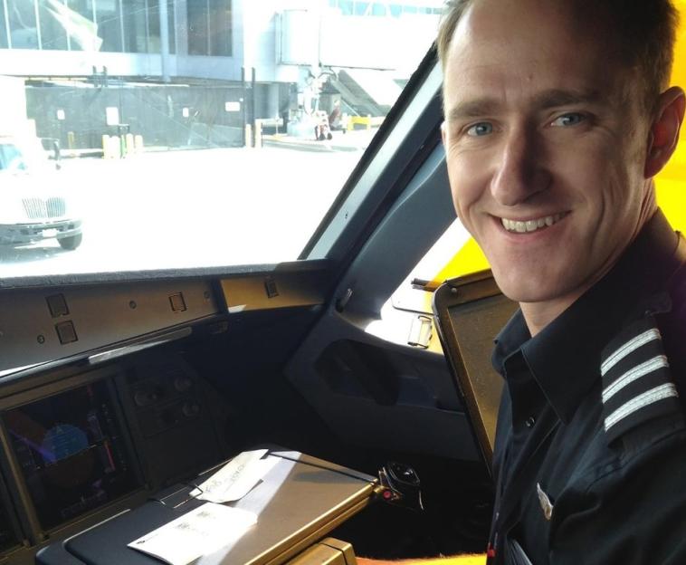 Smiling pilot in cockpit.