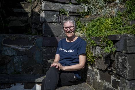 Ronna Halsall, author, sitting in her garden near Dinorwig Quarry.