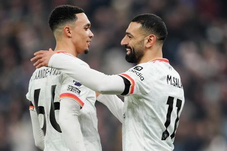 Mohamed Salah and Trent Alexander-Arnold embracing.
