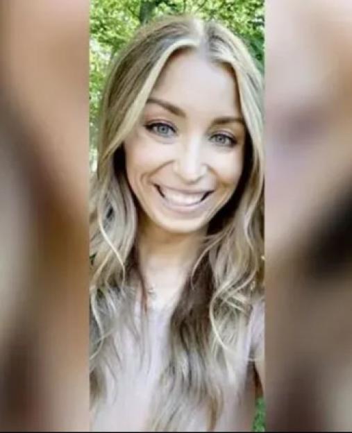 Photo of a smiling woman with long blonde hair.