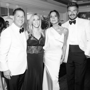 Black and white photo of David Beckham and Victoria Beckham at a party.