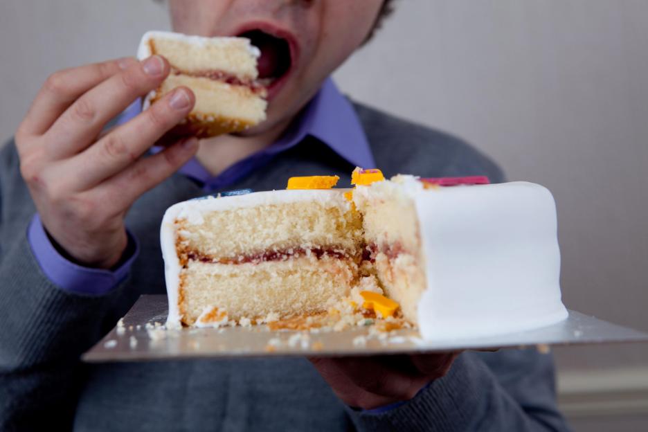 Person eating a piece of cake.