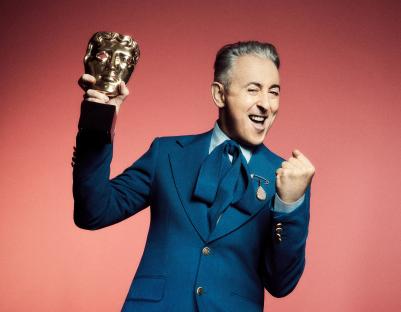 Alan Cumming, host of the 2025 BAFTA TV Awards, holding a BAFTA award.