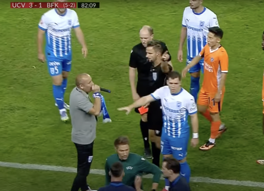Screenshot of a soccer game where a referee shows a red card to a player.