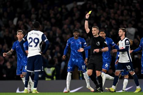 Referee showing a yellow card to a soccer player.