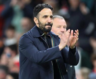 Ruben Amorim applauding fans at a Manchester United game.