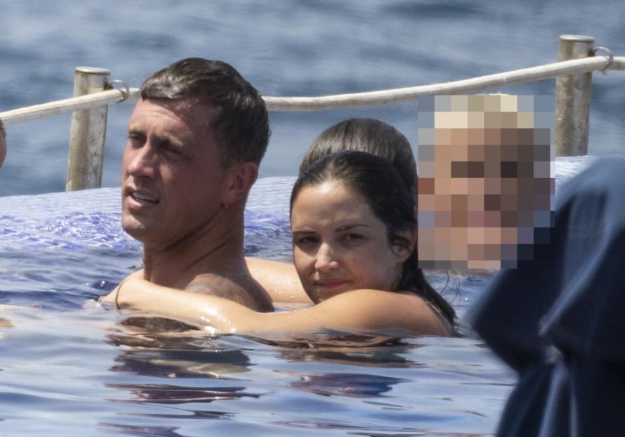Jacqueline Jossa and Dan Osborne on a family holiday in a pool.