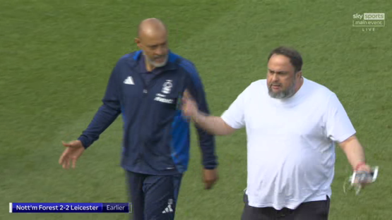 Two men interacting on a soccer field.