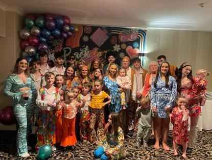 Large family in 1970s-style clothing.