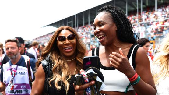 Venus and Serena Williams laughing at the F1 Grand Prix of Miami.