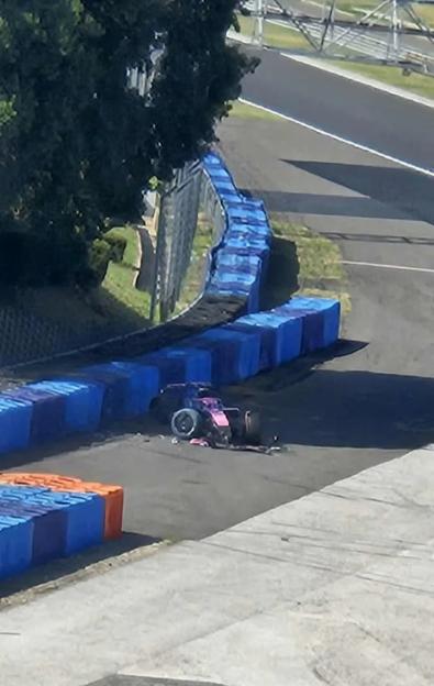 Damaged Formula 1 car on racetrack.