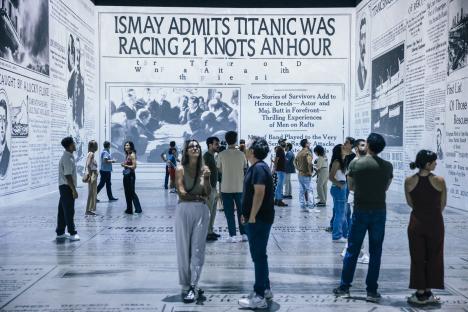 A first-of-its-kind Titanic exhibition featuring large-scale newspaper print reproductions and visitors.