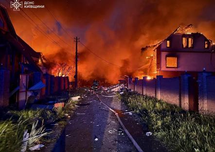 Firefighters battling a fire in a residential area after a Russian strike in Kyiv.