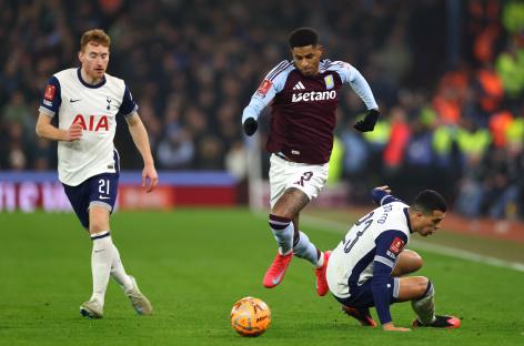 Marcus Rashford of Aston Villa dribbling the ball past Tottenham Hotspur players.