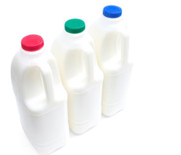 Three milk cartons with red, green, and blue lids.
