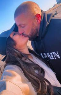 Couple kissing on a beach.
